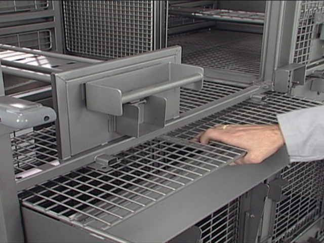 lab technician operating a Modular Primate Cage Unit